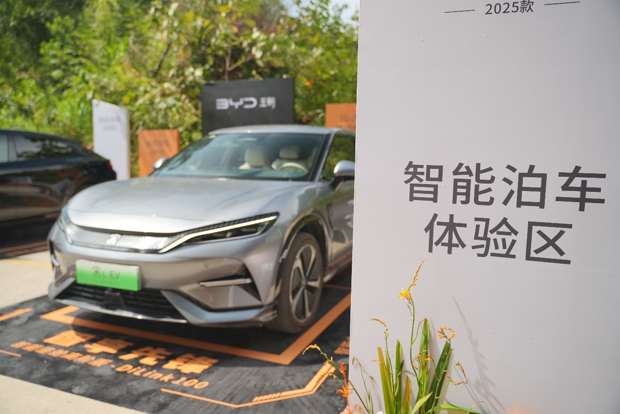 The advertisement on the wall is on the side of the car.Medium confidence description has been generated automatically.